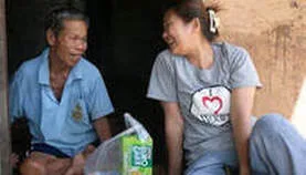 Access to Care brings a smile to an elder Thai man with supplies and companionship