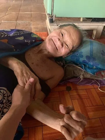 Smile of gratitude on a senior, disabled woman happy to see our Team from Access to Care Home Visiting program.