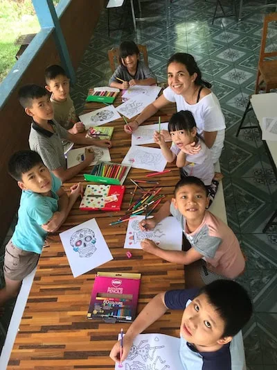 Volunteer working with a group of children at Warm Heart in Thailand