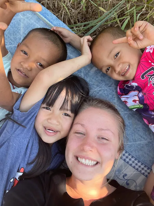 Volunteer enjoying a minute of rellaxation with the kids